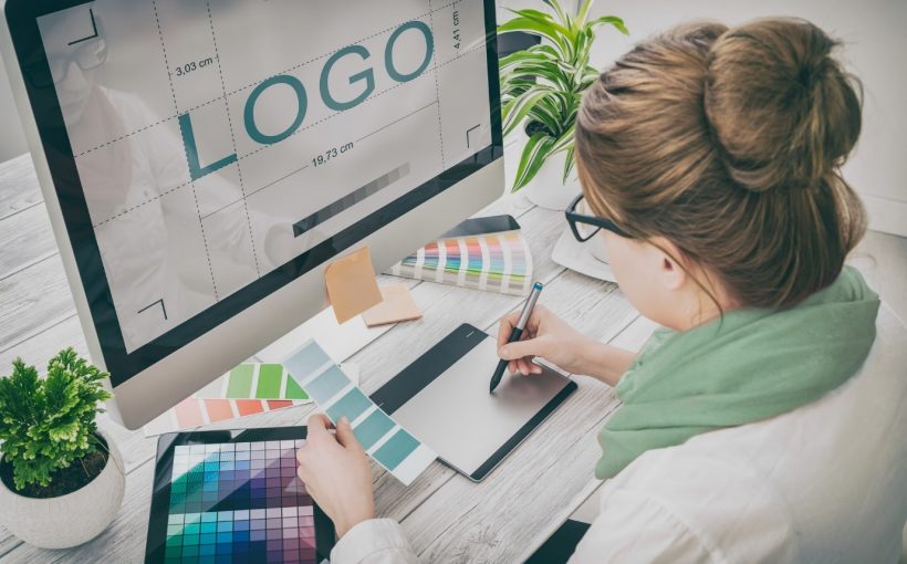 Designer reviewing logo concepts on a computer